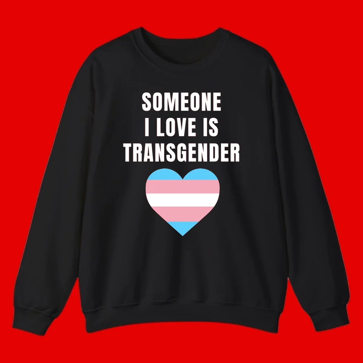 Gray background with white text reading 'Someone I Love Is Transgender' above a heart featuring blue, pink, and white transgender flag stripes