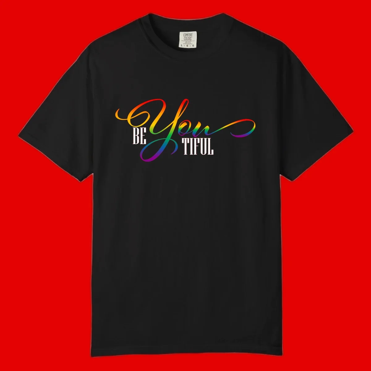Colorful be-you-them-pride design with flowing rainbow gradient text transitioning from red to purple on gray background