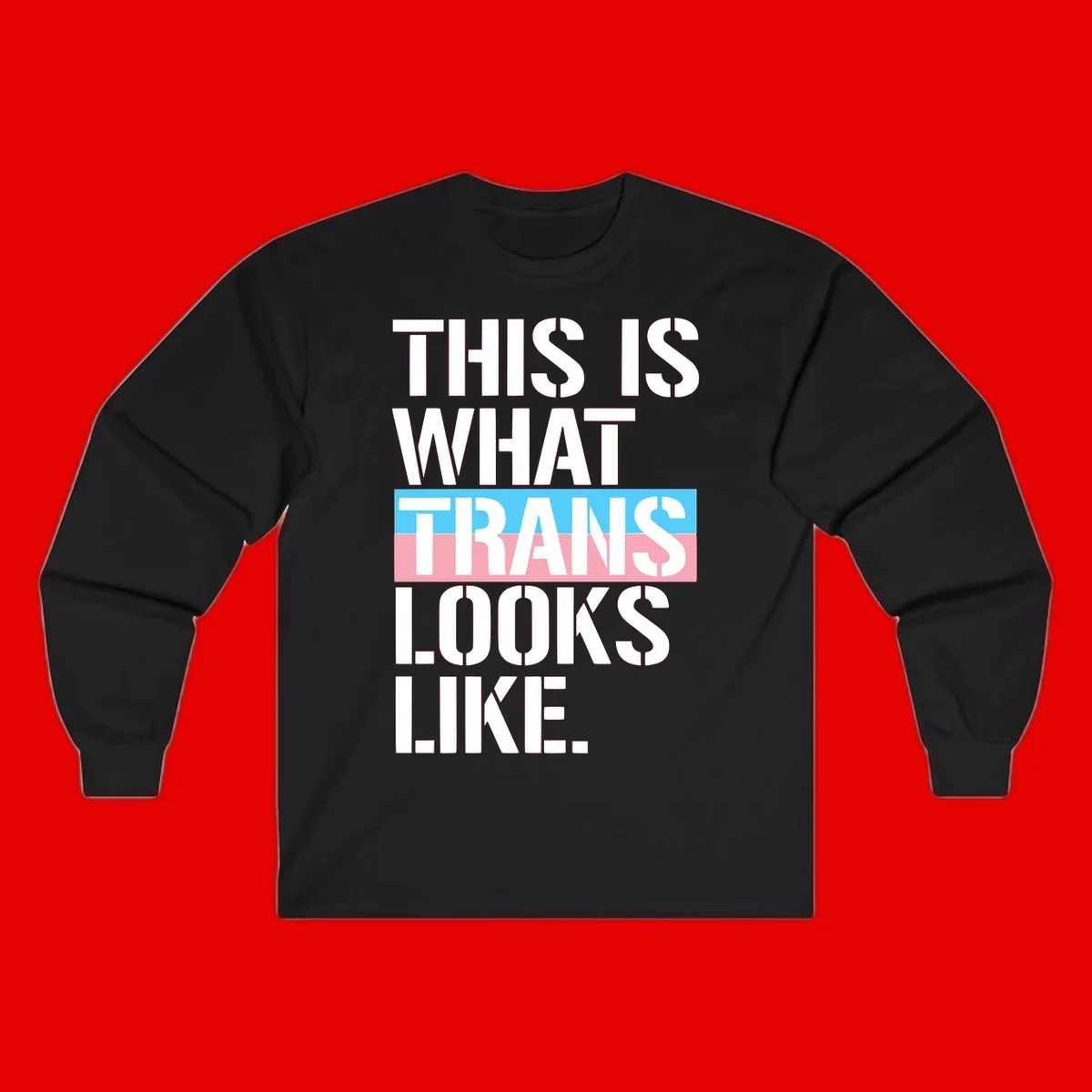 Bold typography design reading 'THIS IS WHAT TRANS LOOKS LIKE' with trans pride flag colors in blue and pink stripe