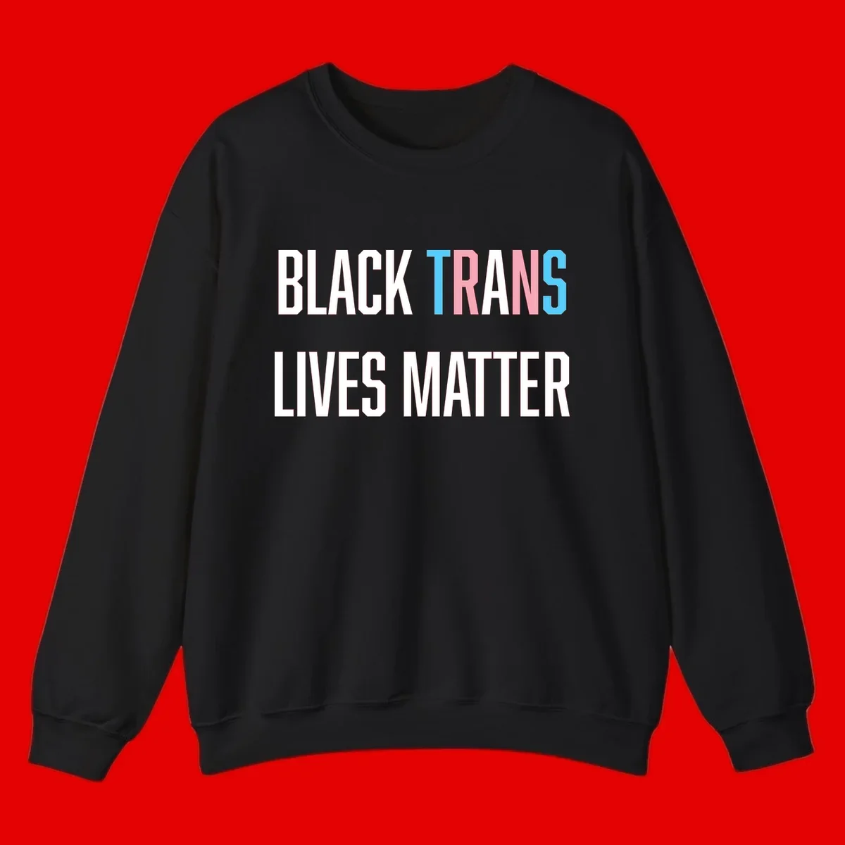 Bold typography design reading 'BLACK TRANS LIVES MATTER' with 'TRANS' in pink and cyan pride colors on gray background
