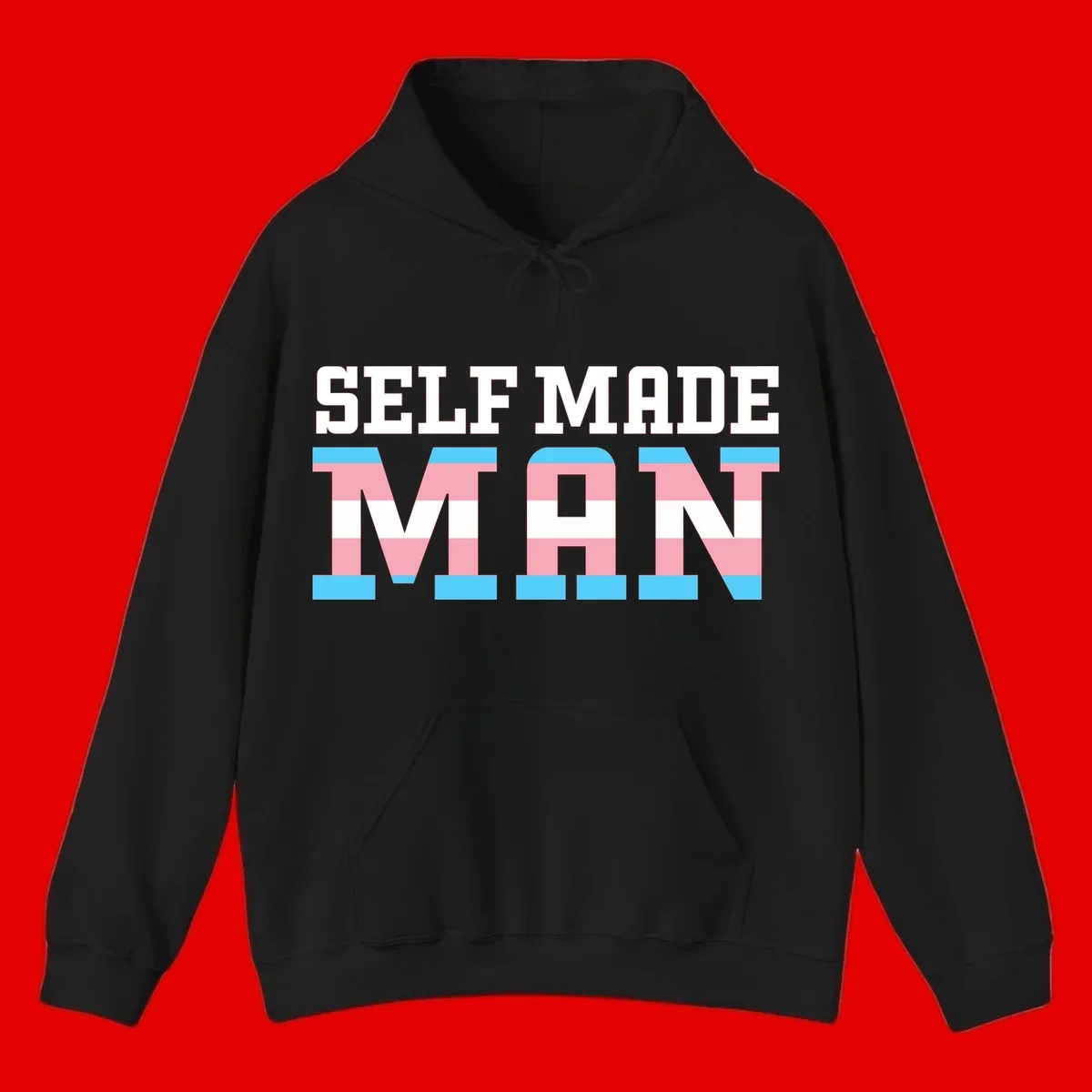 Bold 'Self Made' text filled with transgender pride flag stripes in blue, pink, and white on gray background