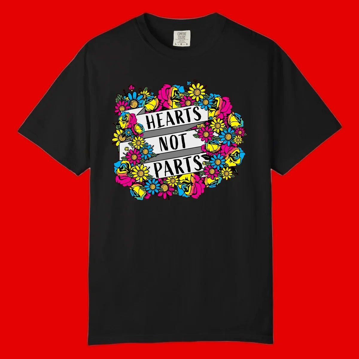 Hearts Not Parts pride design with colorful floral wreath featuring yellow daisies, magenta roses, and blue flowers surrounding bold statement text