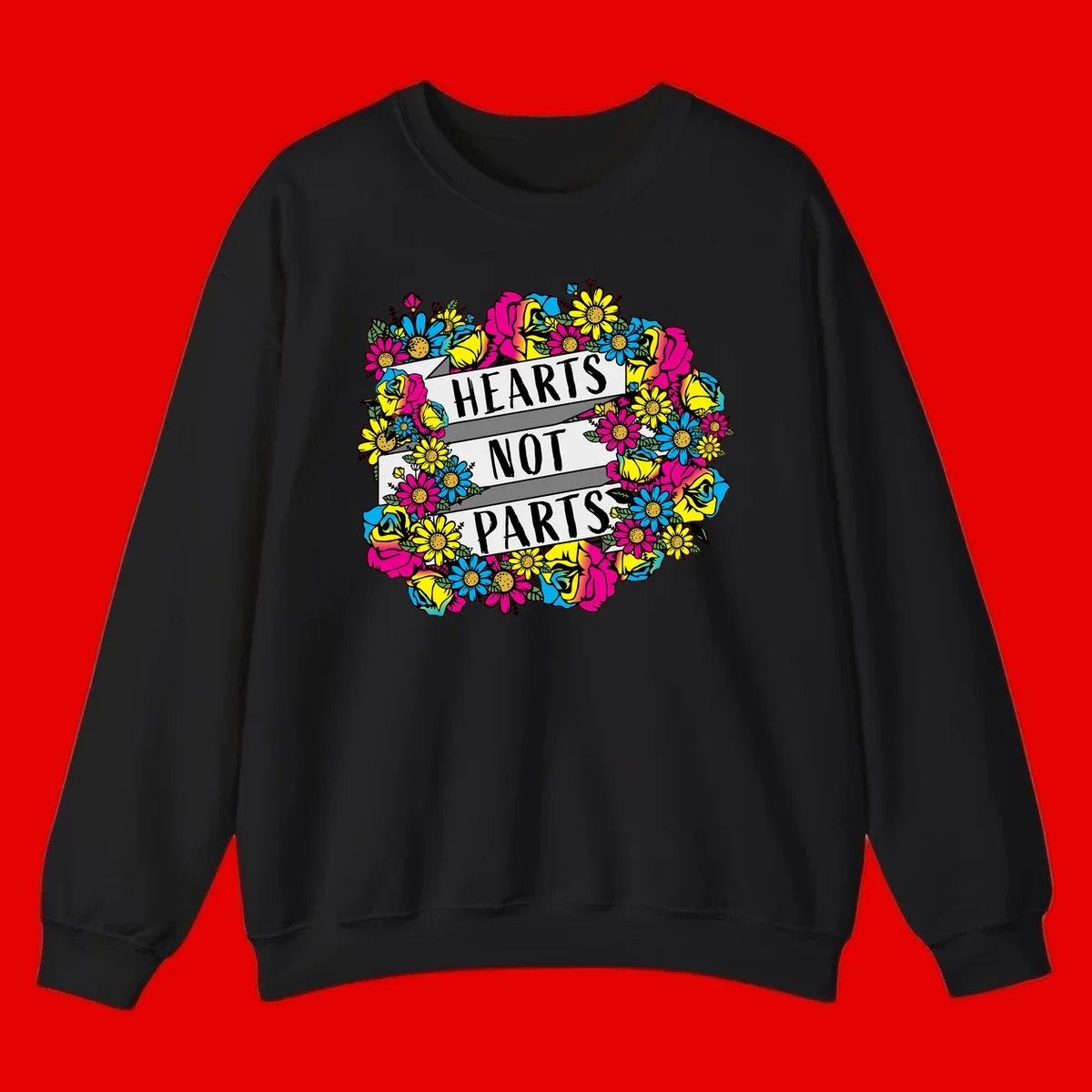 Hearts Not Parts pride design with colorful floral wreath featuring yellow daisies, magenta roses, and blue flowers surrounding bold statement text