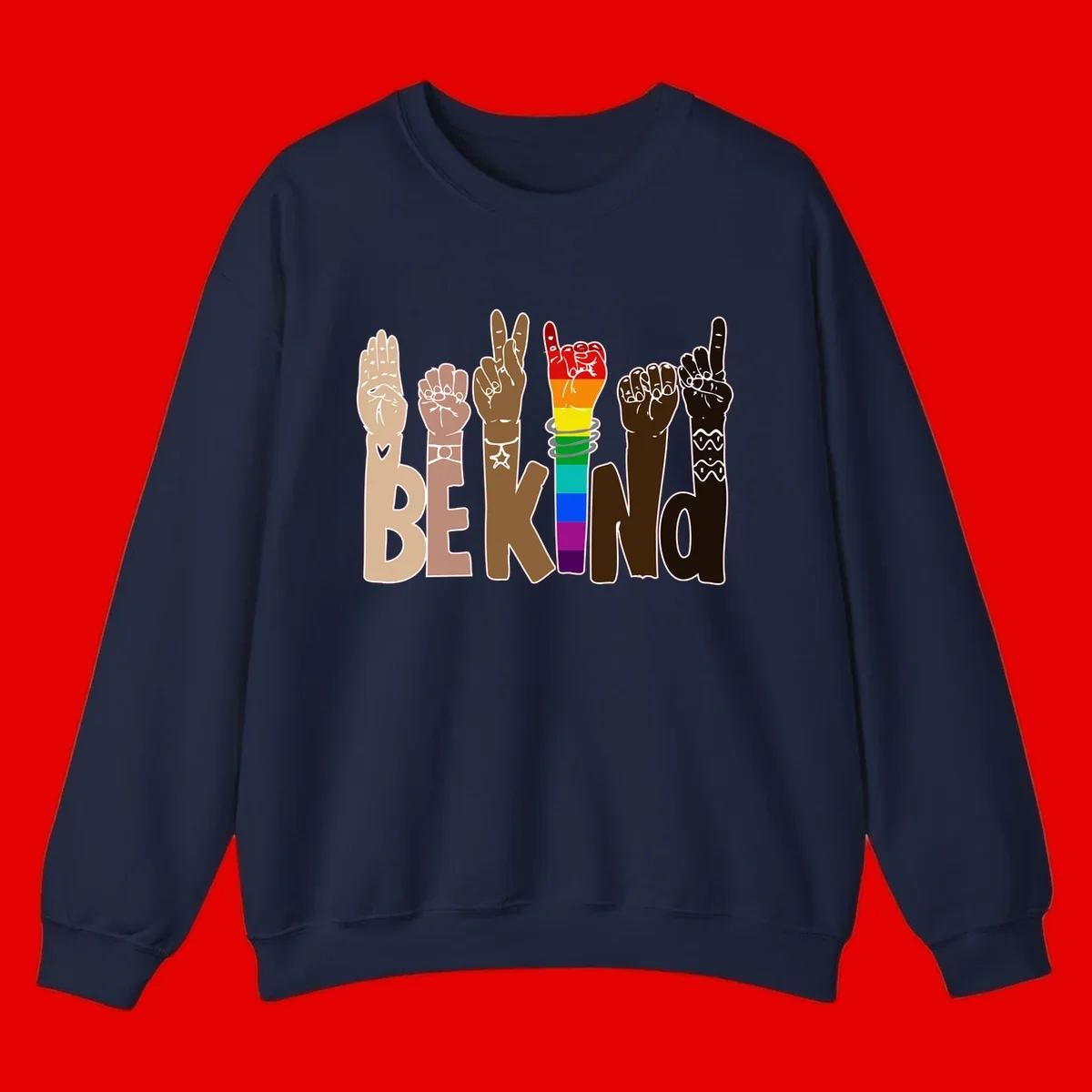 Six illustrated hands in diverse skin tones displaying peace signs and fists, with center fist in rainbow pride colors and 'BE KIND' text below