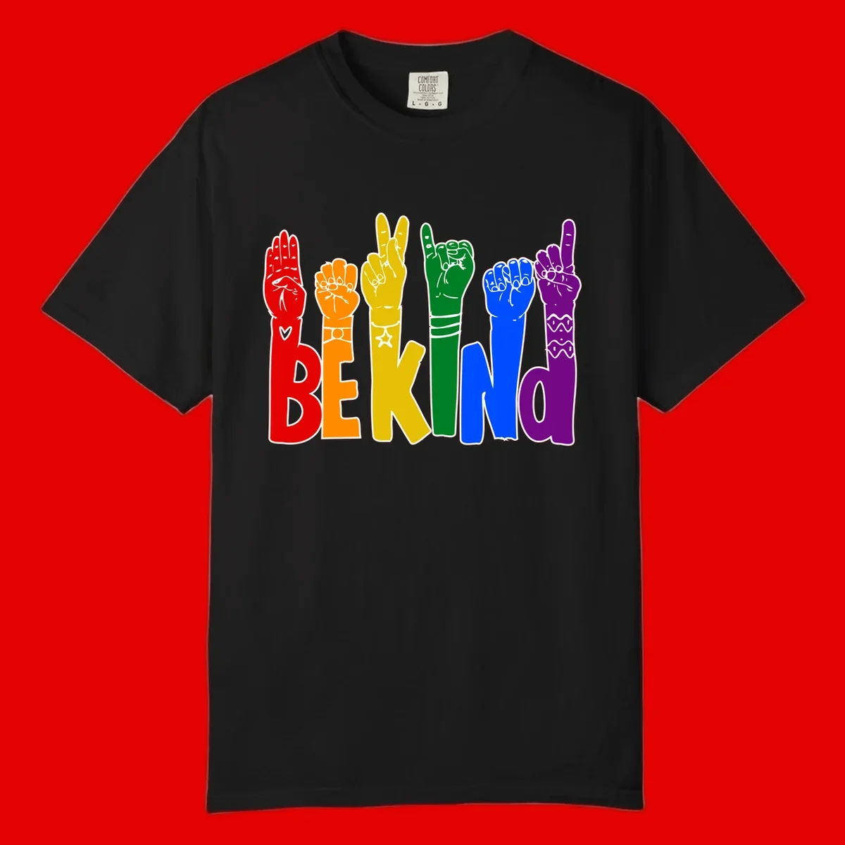 Six colorful raised fists in rainbow colors with 'BE KIND' text, promoting pride, equality, and inclusive messaging