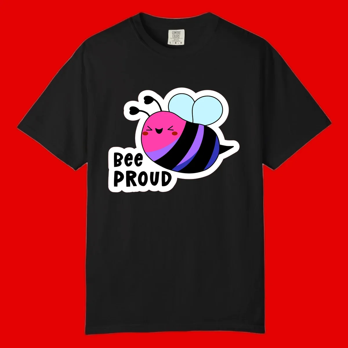 Colorful cartoon bee with pink head, rainbow-striped body, light blue wings, smiling face, and 'BEE PROUD' text