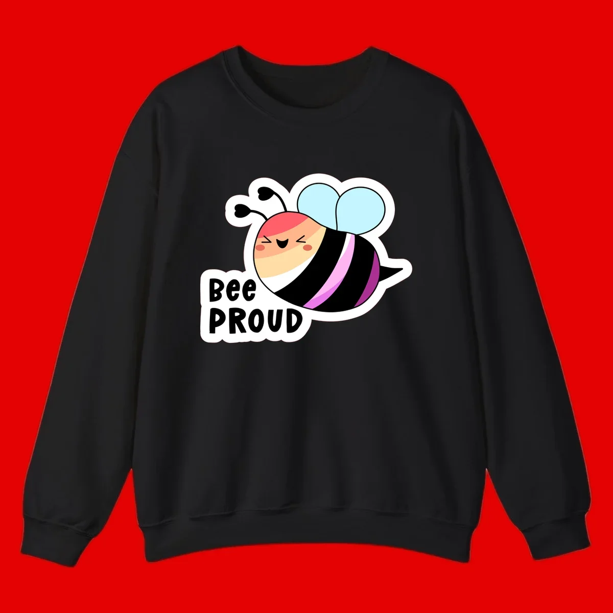 Cheerful cartoon bee with peach face and pink-striped body next to 'Bee Proud' text celebrating pride and individuality