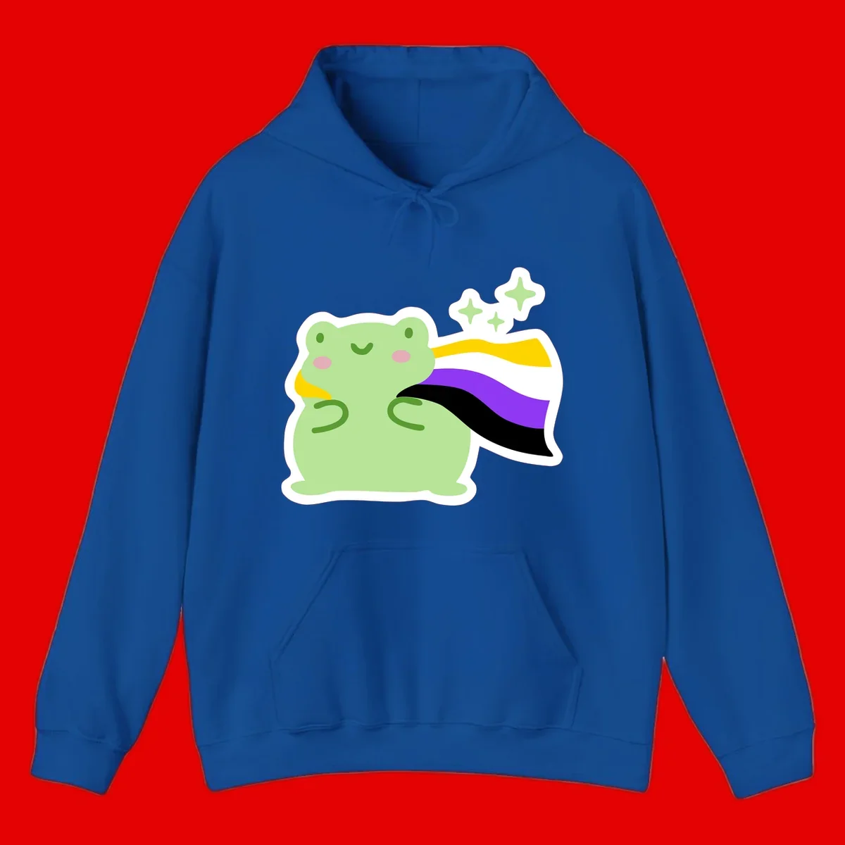 Cute green frog with pink cheeks wearing a yellow, purple, and black rainbow cape with floating sparkle stars