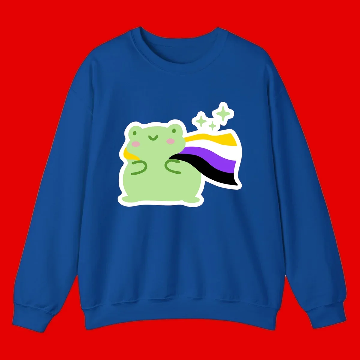 Cute green frog with pink cheeks wearing a yellow, purple, and black rainbow cape with floating sparkle stars
