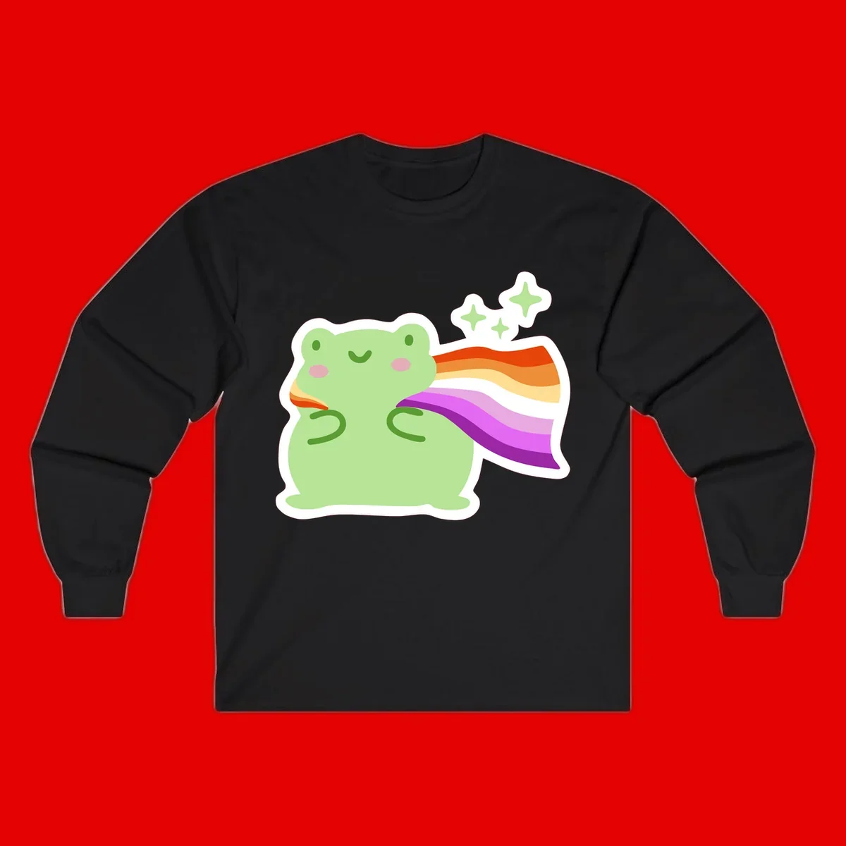 Cute green frog with pink cheeks wearing a rainbow pride cape, surrounded by sparkle stars
