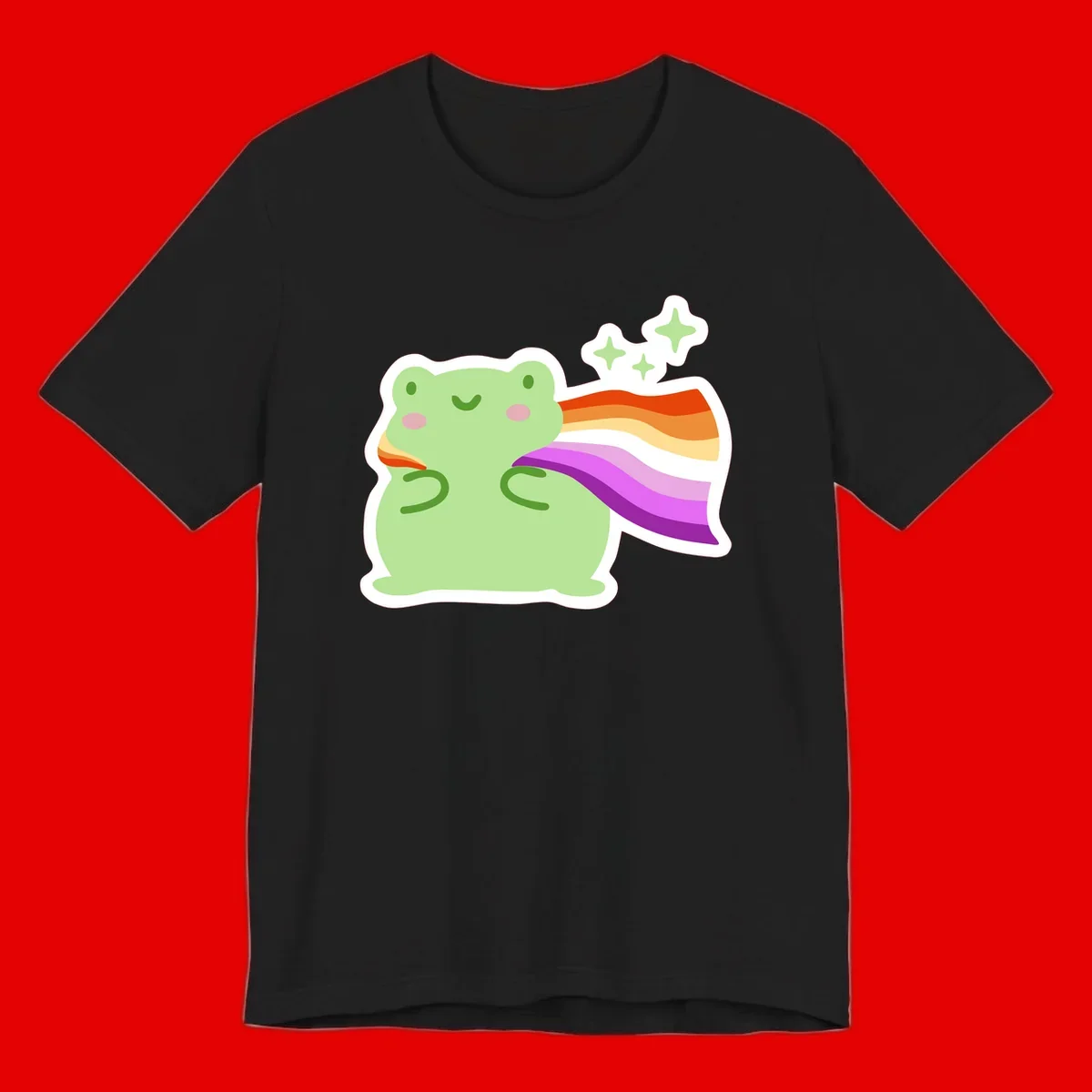 Cute green frog with pink cheeks wearing a rainbow pride cape, surrounded by sparkle stars