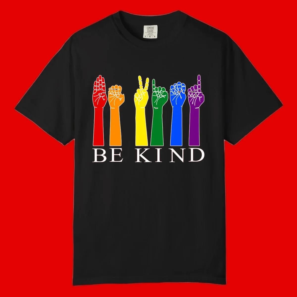 Six rainbow-colored raised hands in red, orange, yellow, green, blue, and purple with white line details and 'BE KIND' text below