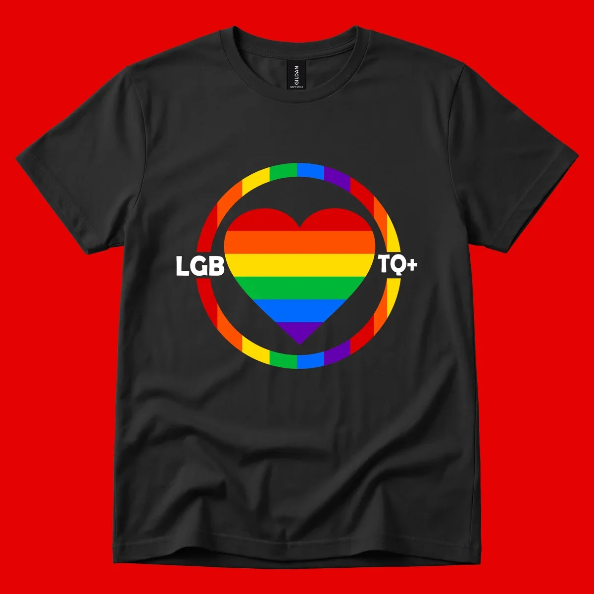 Rainbow heart with LGB TO+ text in concentric pride circles on gray background