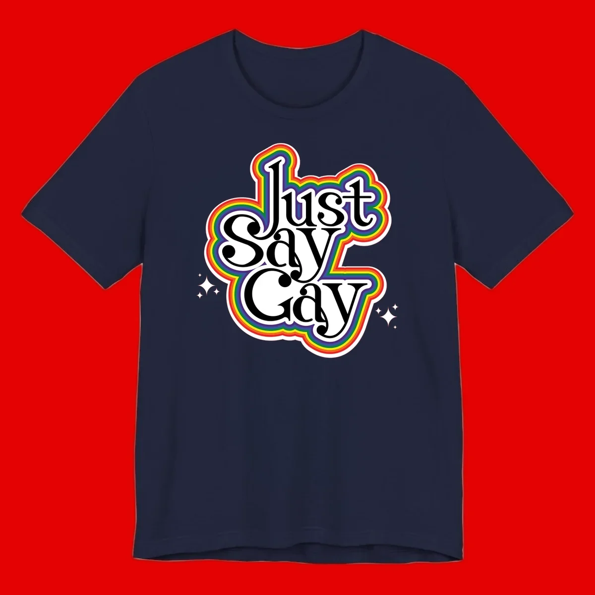 Just Say Gay Pride design with bold black text surrounded by vibrant rainbow border and sparkle accents on gray background
