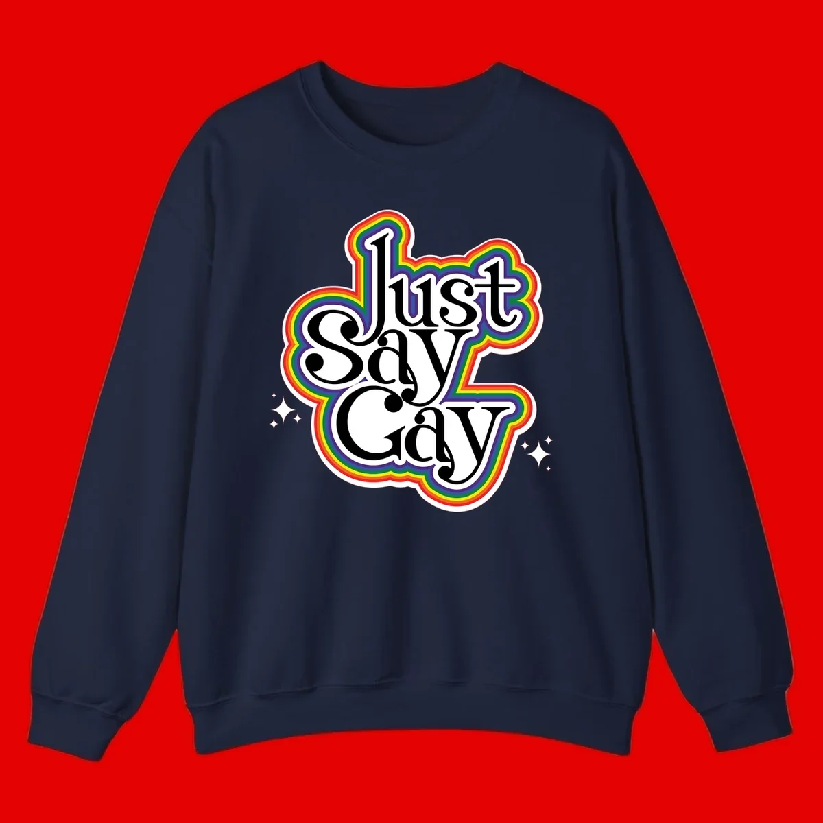 Just Say Gay Pride design with bold black text surrounded by vibrant rainbow border and sparkle accents on gray background