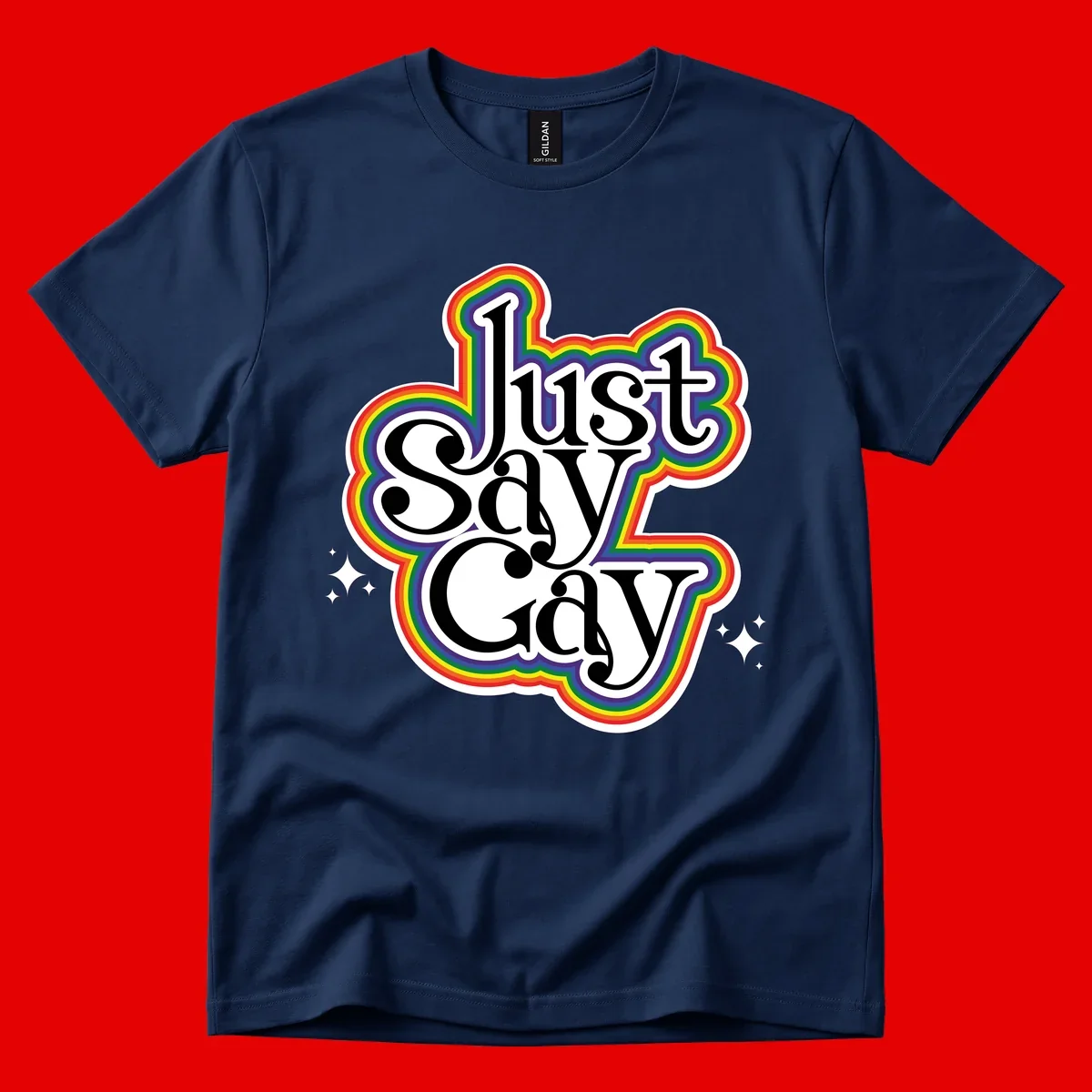 Just Say Gay Pride design with bold black text surrounded by vibrant rainbow border and sparkle accents on gray background