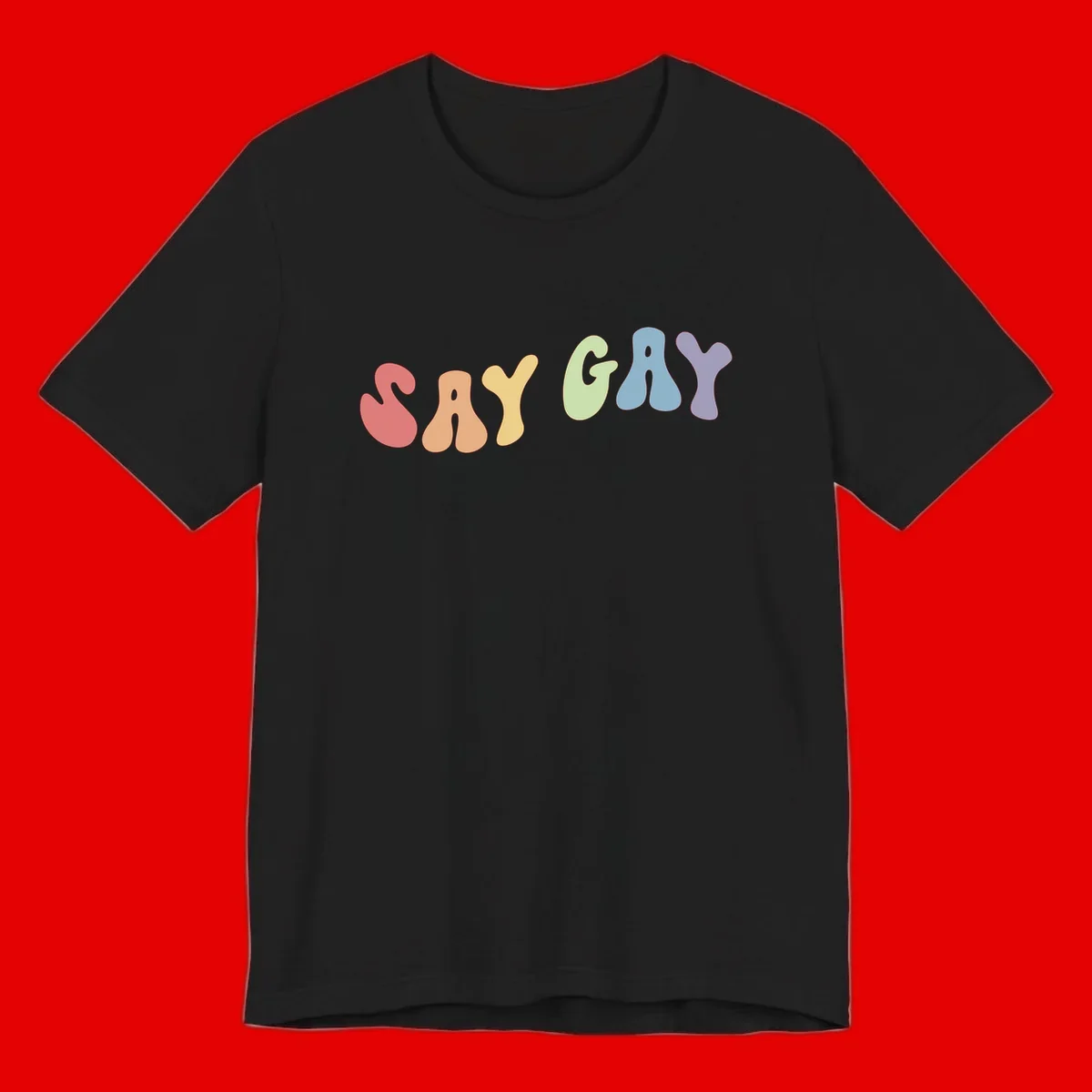 Colorful bubble letters spelling SAY GAY in rainbow pride colors: red, peach, yellow, green, blue, and purple on gray background