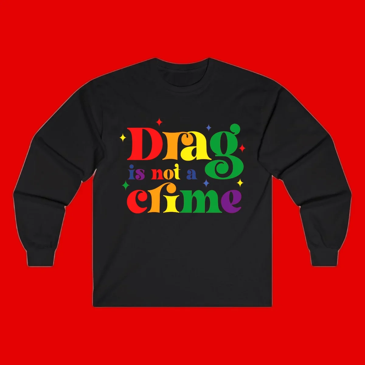 Colorful rainbow typography spelling 'Drag is not a crime' with decorative stars on gray background
