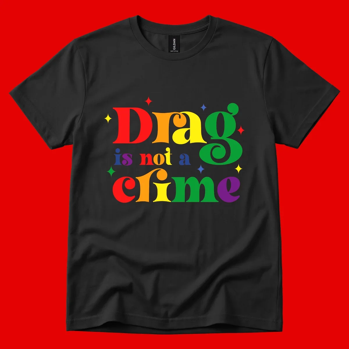 Colorful rainbow typography spelling 'Drag is not a crime' with decorative stars on gray background