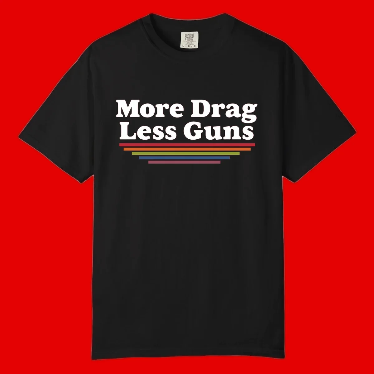 More Drag Less Guns design: white text on gray background with colored horizontal bars representing pride and activism