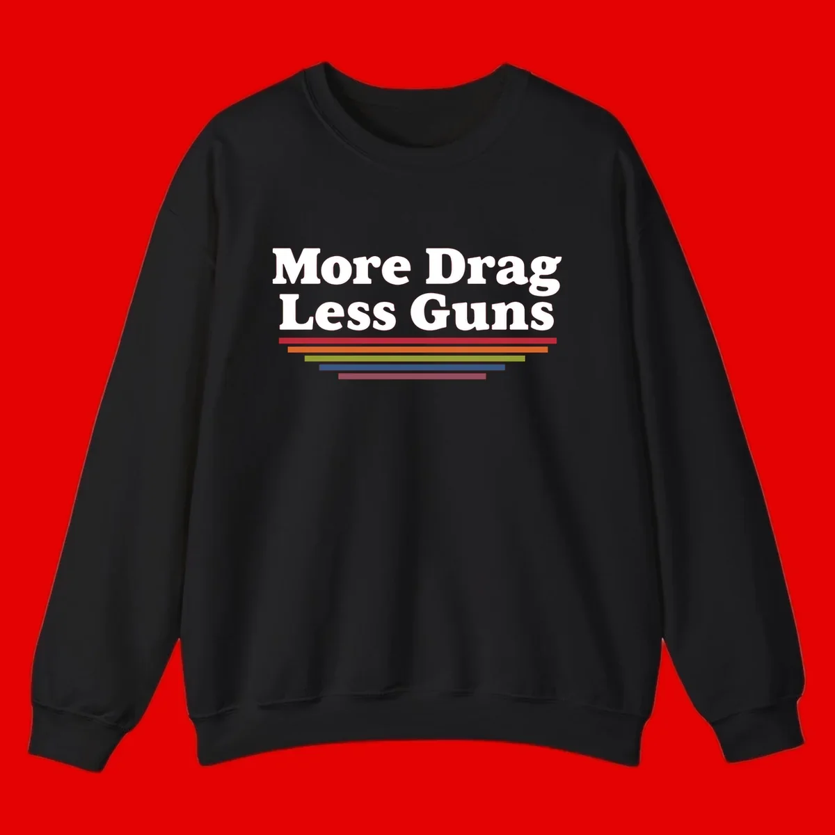 More Drag Less Guns design: white text on gray background with colored horizontal bars representing pride and activism