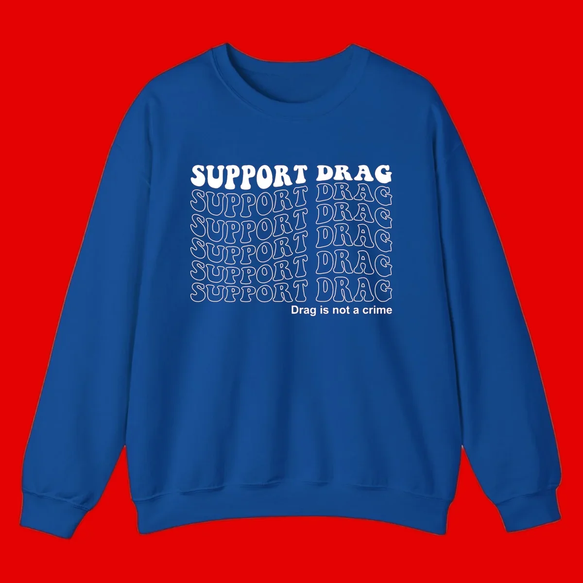 Gray t-shirt design with white text reading 'Support Drag' repeated throughout and 'Drag is not a crime' at bottom