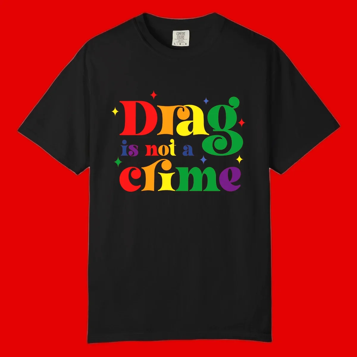 Rainbow gradient text reading 'Drag is not a crime' with colorful stars on gray background