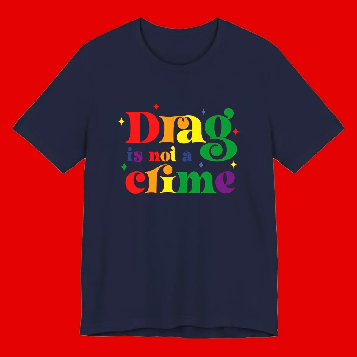 Rainbow gradient text reading 'Drag is not a crime' with colorful stars on gray background