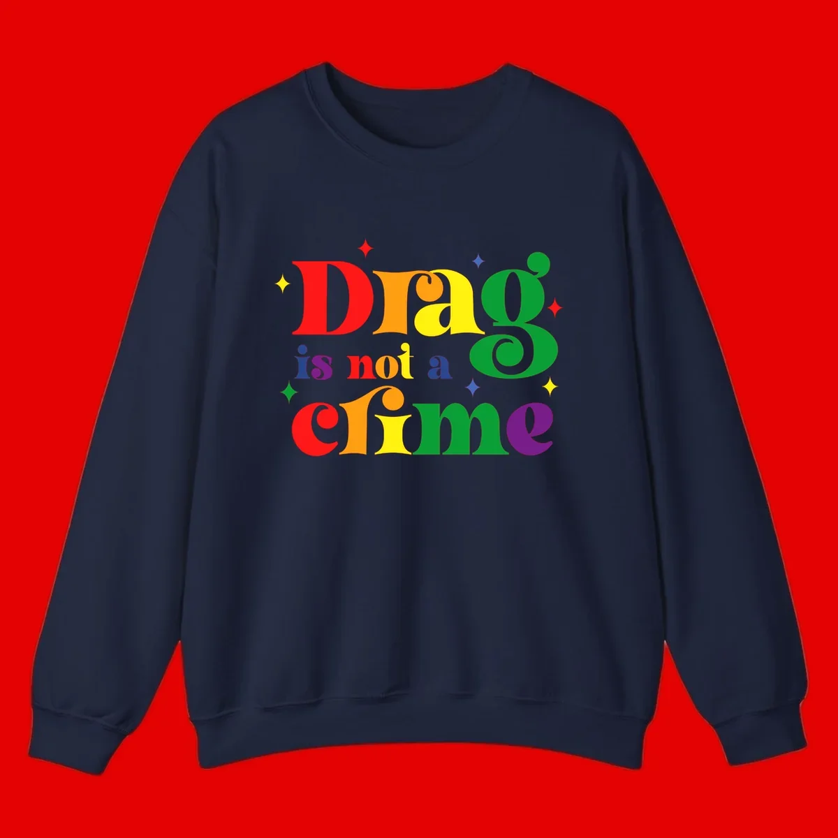 Rainbow gradient text reading 'Drag is not a crime' with colorful stars on gray background