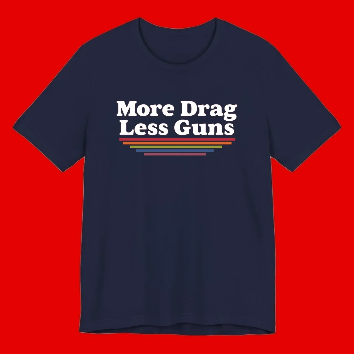 Bold white text reading 'More Drag Less Guns' with colorful horizontal bars below on gray background