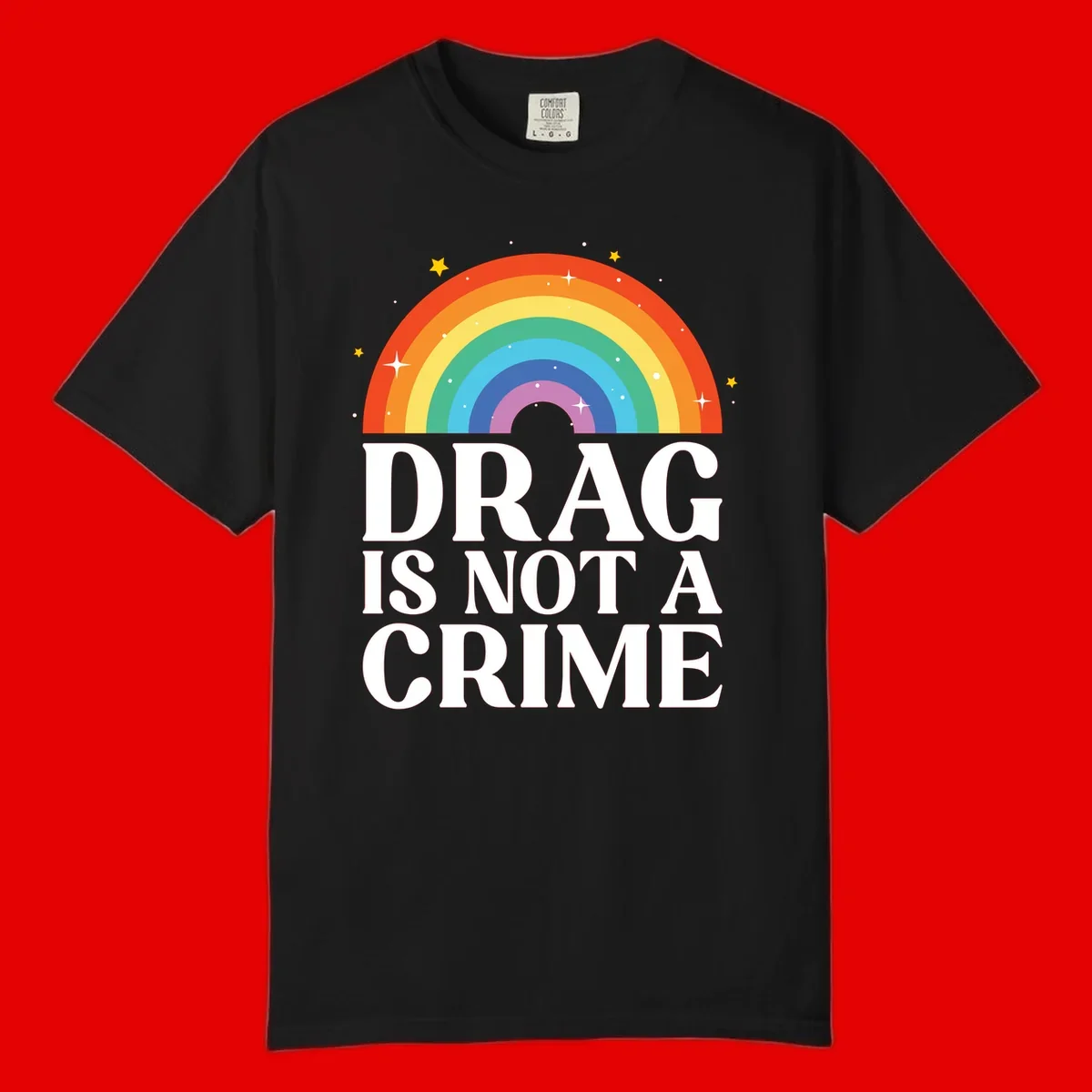Rainbow arc with stars and text reading 'Drag Is Not A Crime' - a pride-themed design celebrating drag rights and LGBTQ+ equality