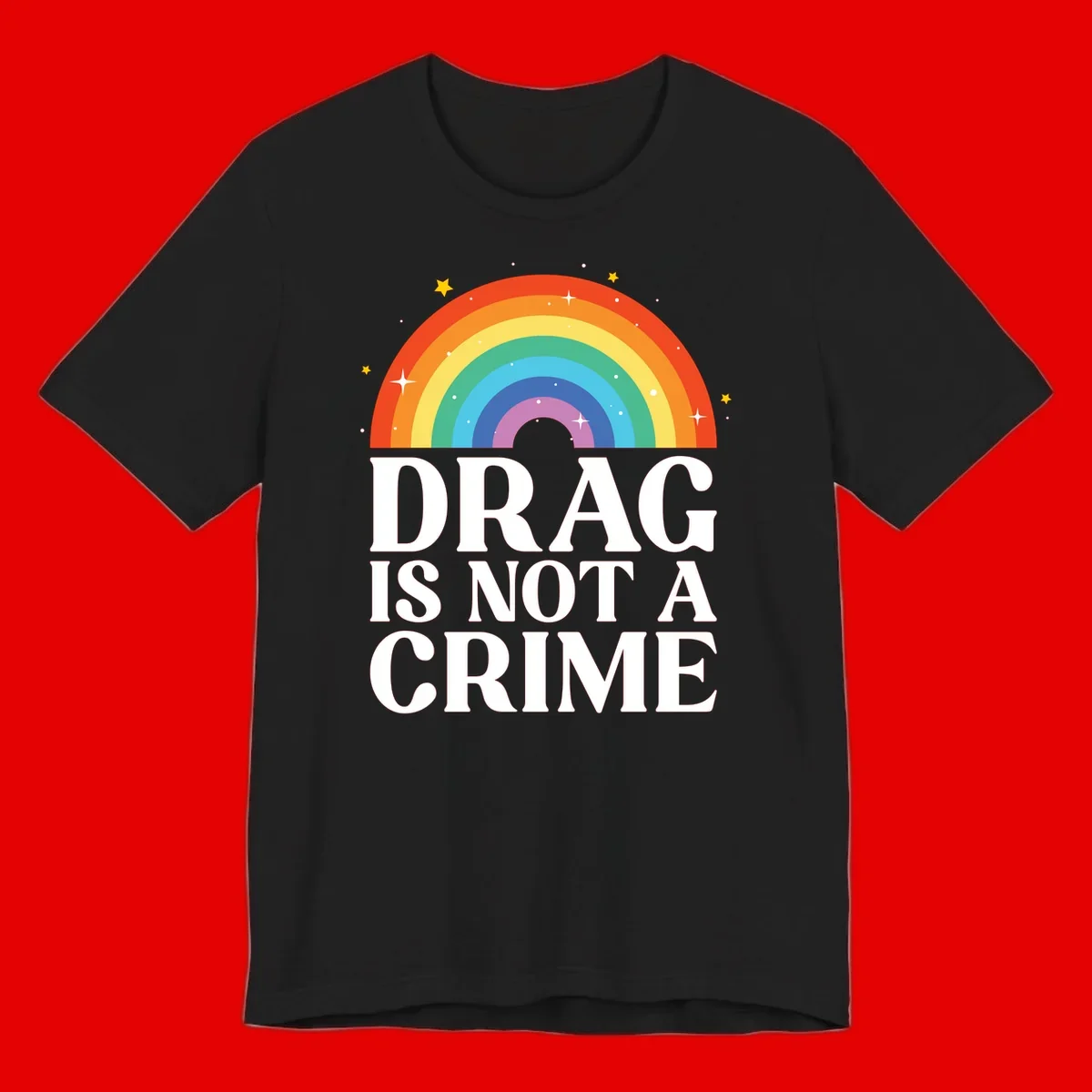 Rainbow arc with stars and text reading 'Drag Is Not A Crime' - a pride-themed design celebrating drag rights and LGBTQ+ equality