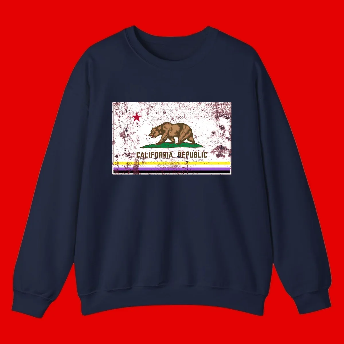 Vintage distressed California Republic bear design with red star, standing on green grass, with yellow, purple, and black pride flag stripes below