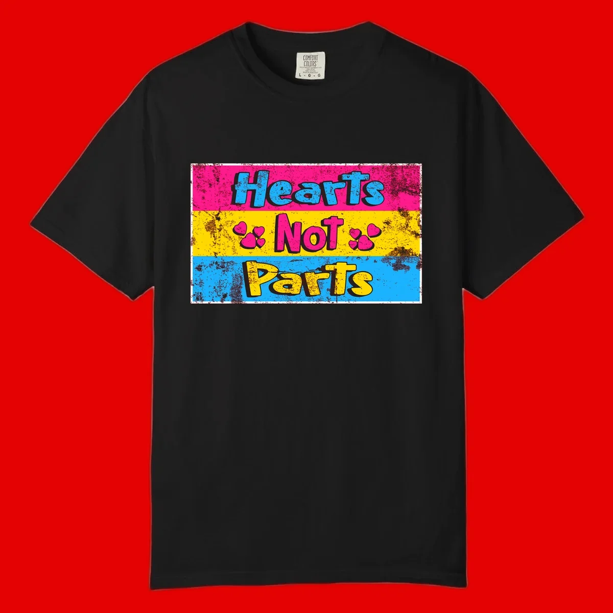 Hearts Not Parts design: magenta, yellow, and blue color-blocked graphic with distressed typography and pink hearts celebrating trans and non-binary identity