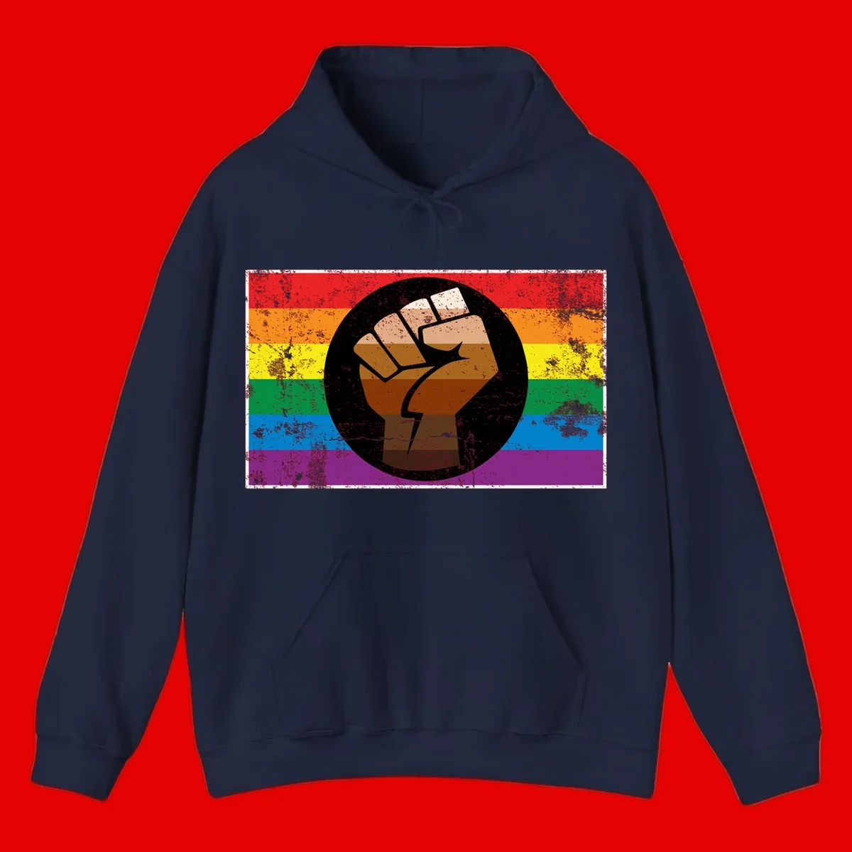 Distressed circular badge featuring a raised brown fist overlaid on a rainbow pride flag background, symbolizing LGBTQ+ solidarity and empowerment