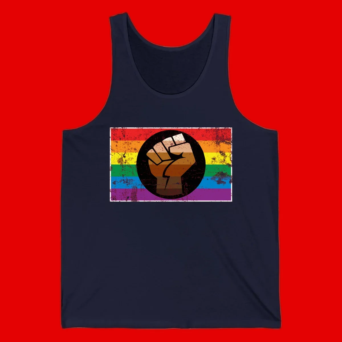 Distressed circular badge featuring a raised brown fist overlaid on a rainbow pride flag background, symbolizing LGBTQ+ solidarity and empowerment