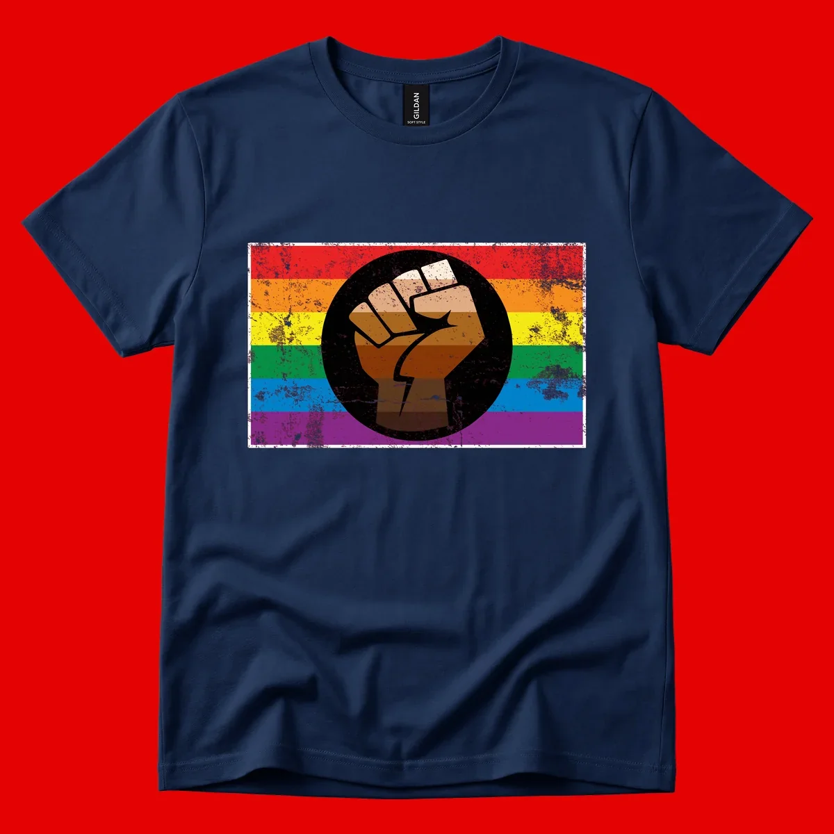 Distressed circular badge featuring a raised brown fist overlaid on a rainbow pride flag background, symbolizing LGBTQ+ solidarity and empowerment