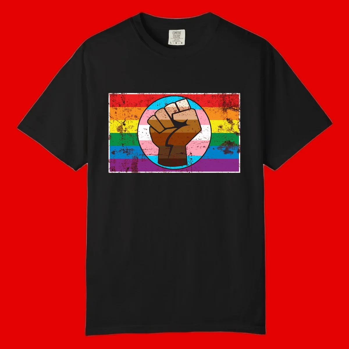 Raised brown fist in circular badge with rainbow pride flag and trans flag stripe background symbolizing LGBTQ+ solidarity