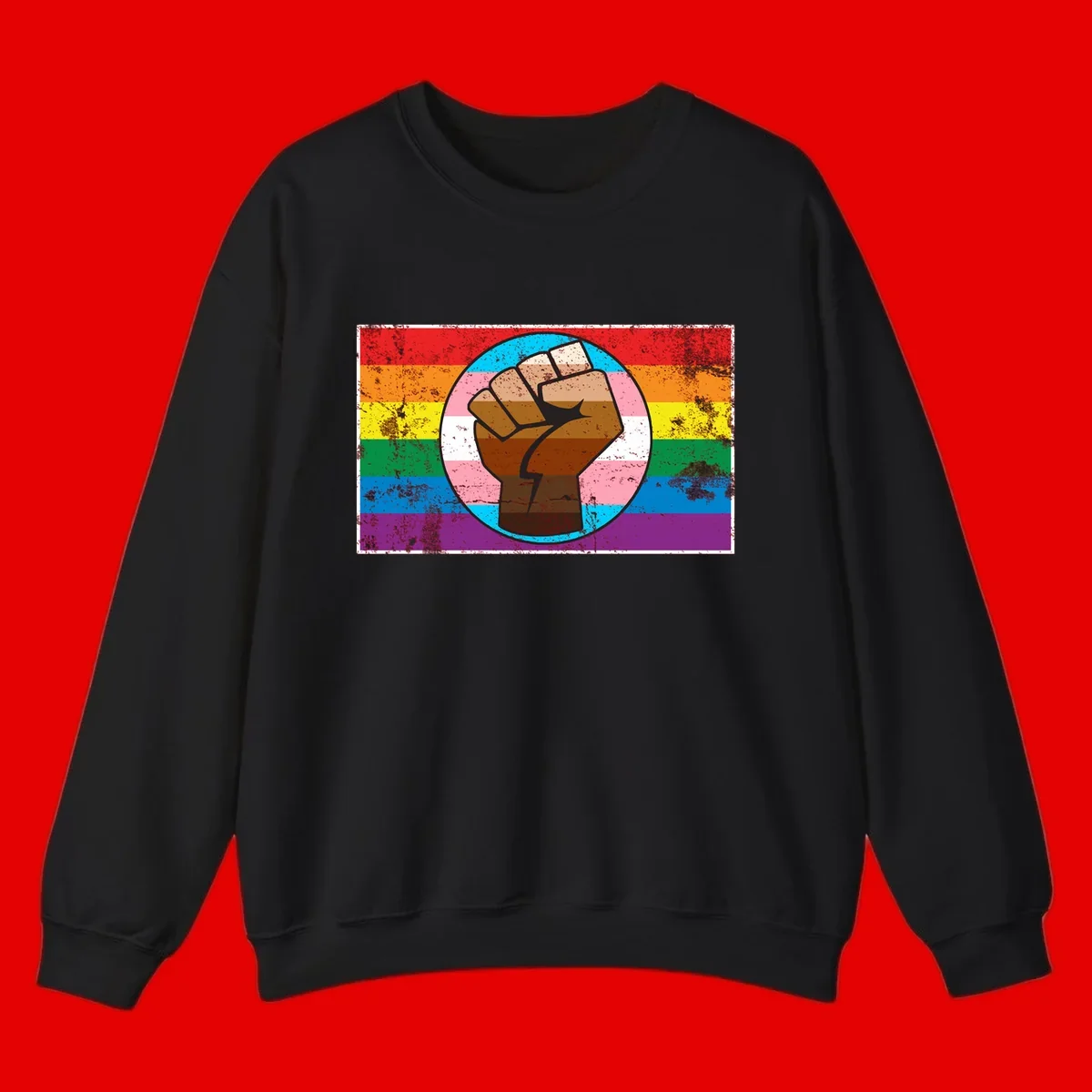 Raised brown fist in circular badge with rainbow pride flag and trans flag stripe background symbolizing LGBTQ+ solidarity