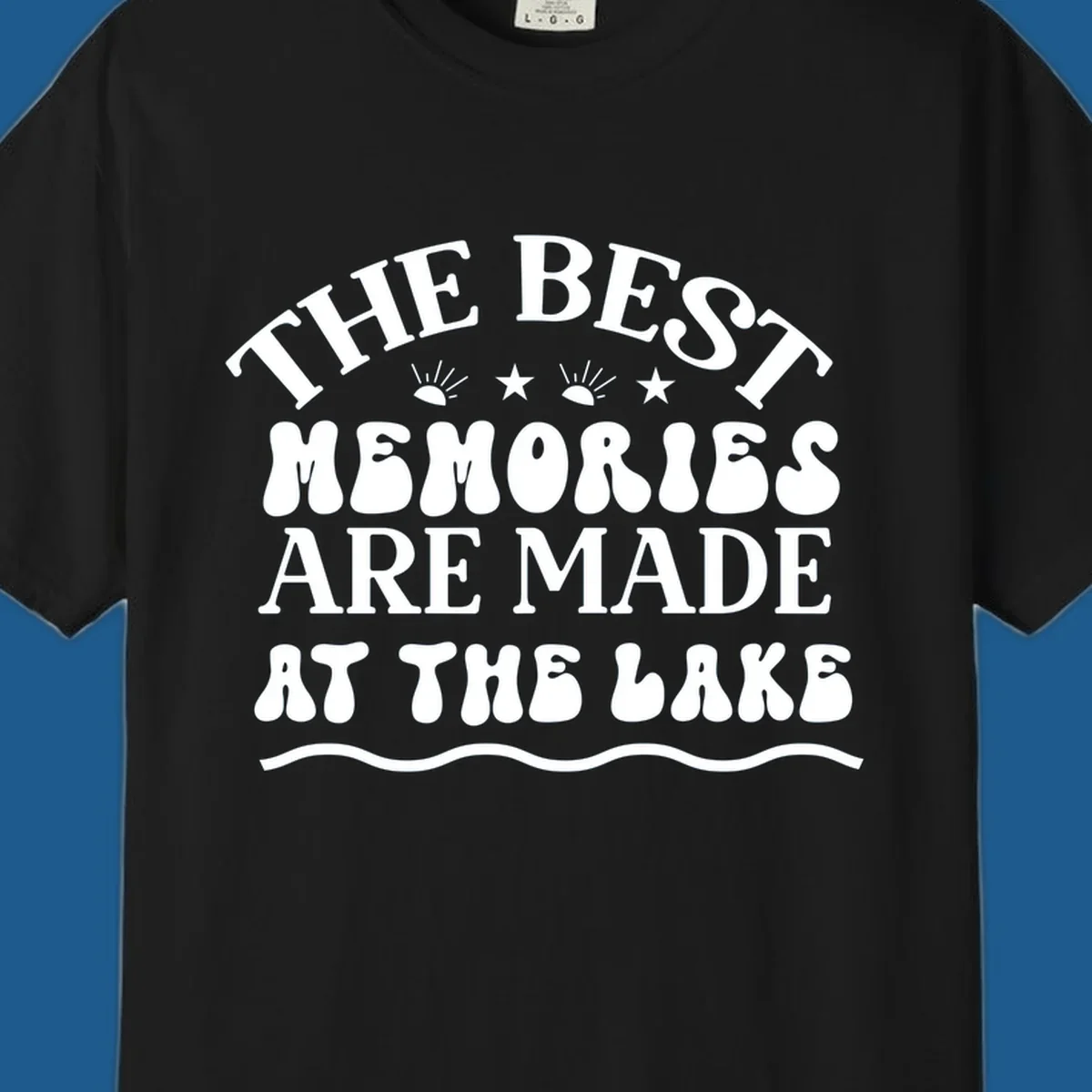 Retro typography design 'The Best Memories Are Made At The Lake' with sun rays and stars.
