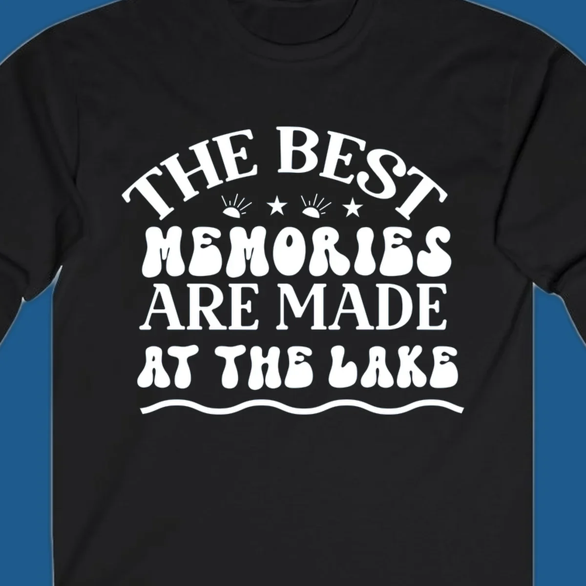 Retro typography design 'The Best Memories Are Made At The Lake' with sun rays and stars.
