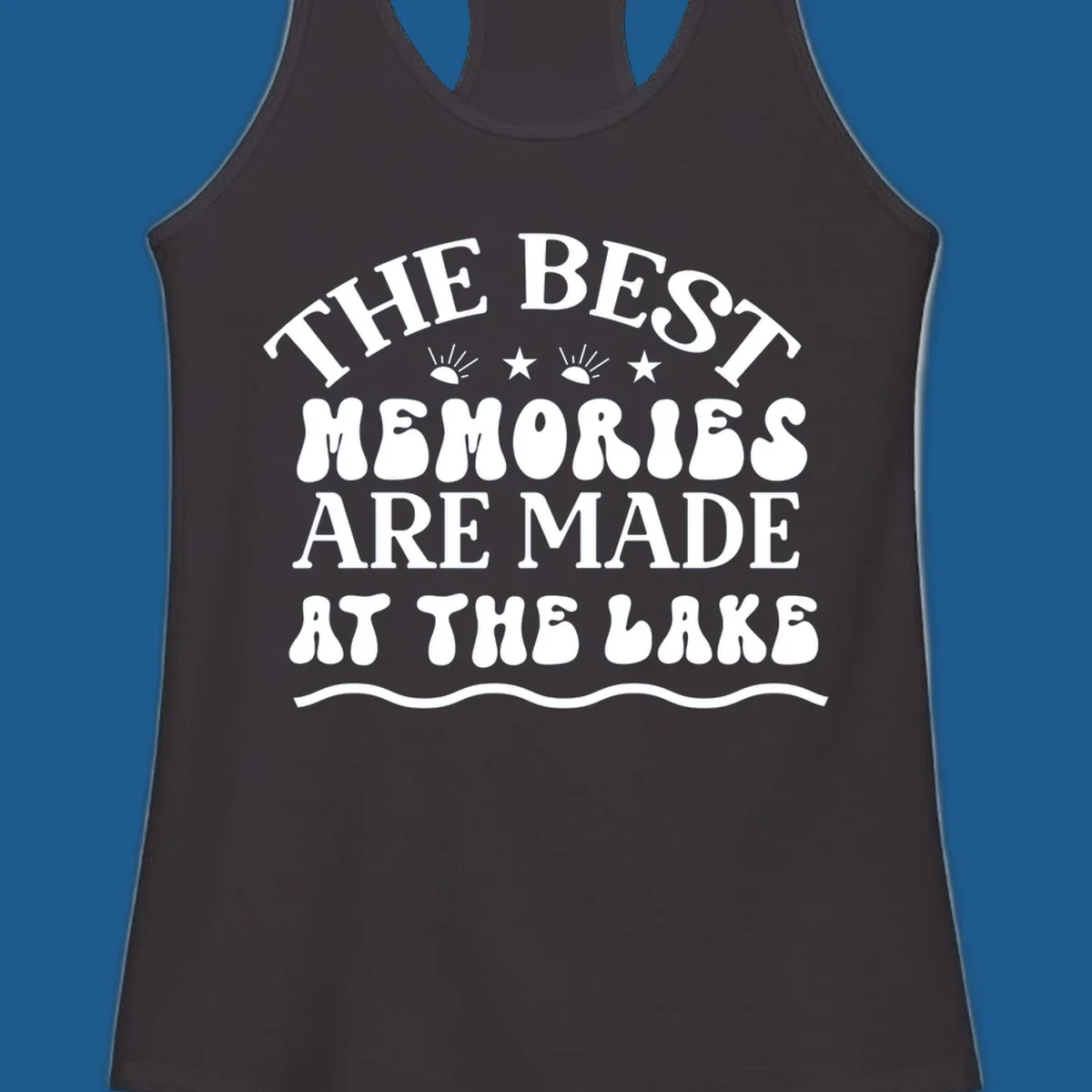 Retro typography design 'The Best Memories Are Made At The Lake' with sun rays and stars.