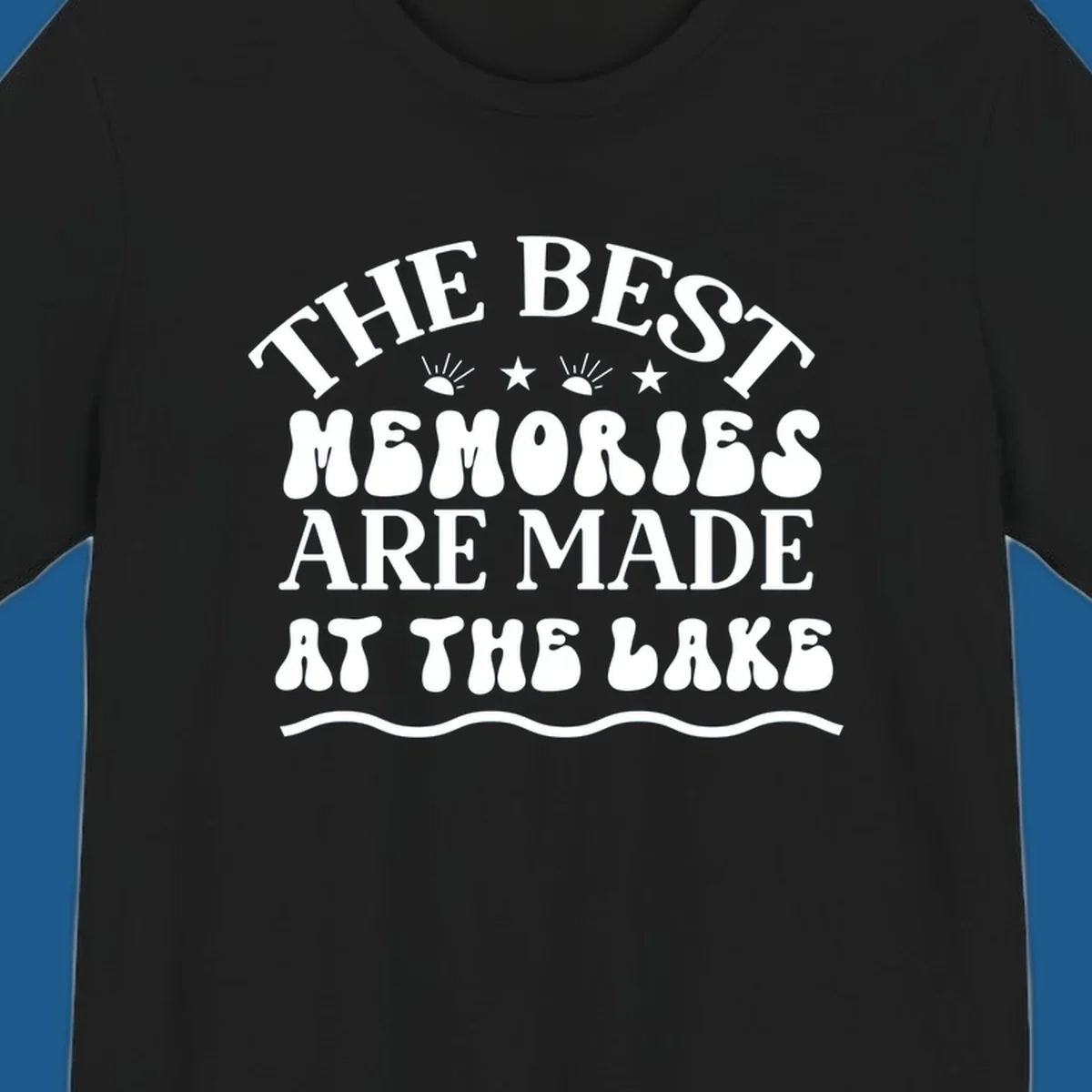 Retro typography design 'The Best Memories Are Made At The Lake' with sun rays and stars.