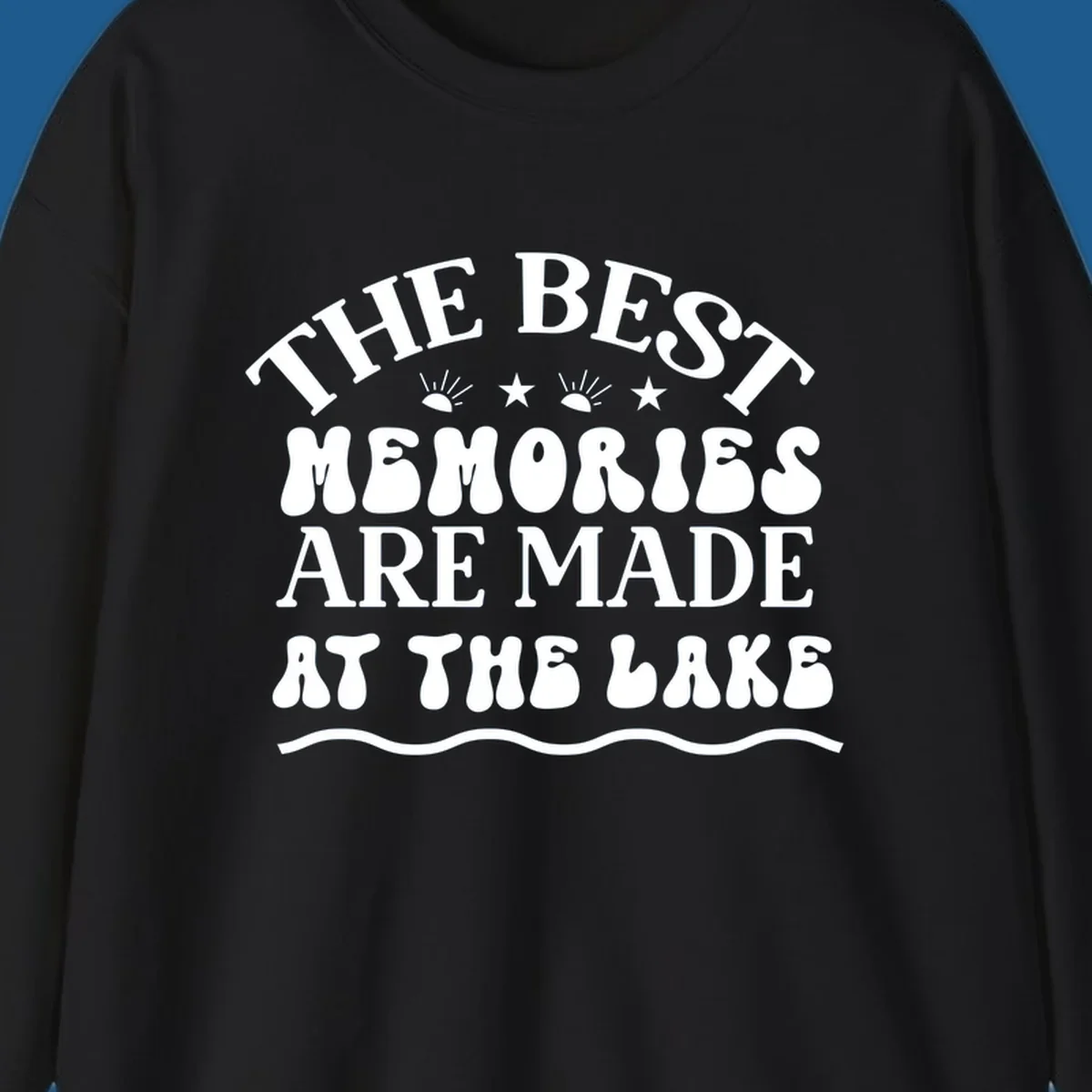 Retro typography design 'The Best Memories Are Made At The Lake' with sun rays and stars.