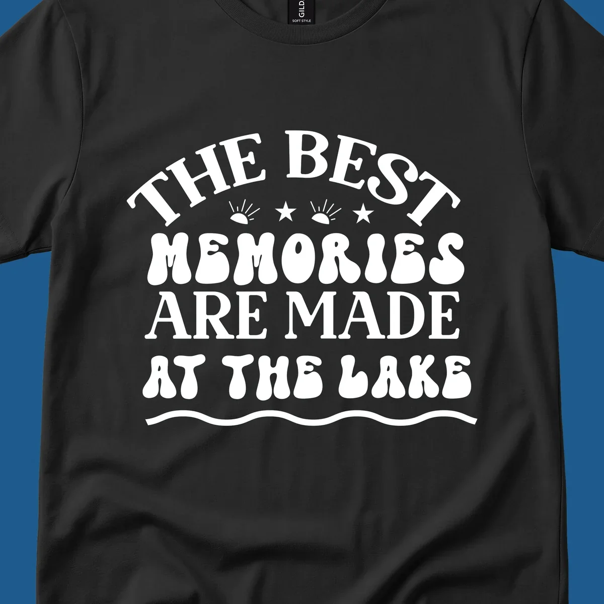 Retro typography design 'The Best Memories Are Made At The Lake' with sun rays and stars.