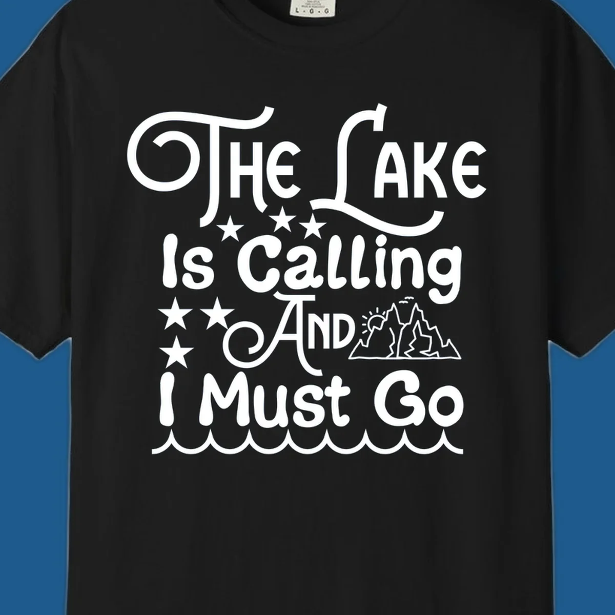 The Lake Is Calling And I Must Go text with mountains and water waves.