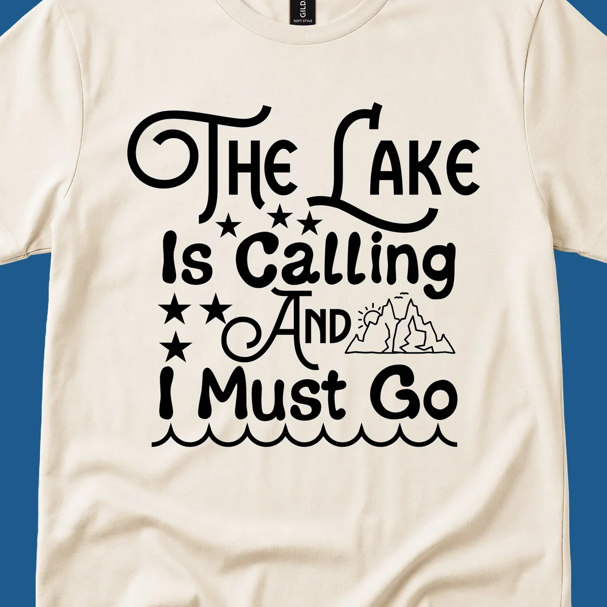 The Lake Is Calling And I Must Go text with mountains and water waves.
