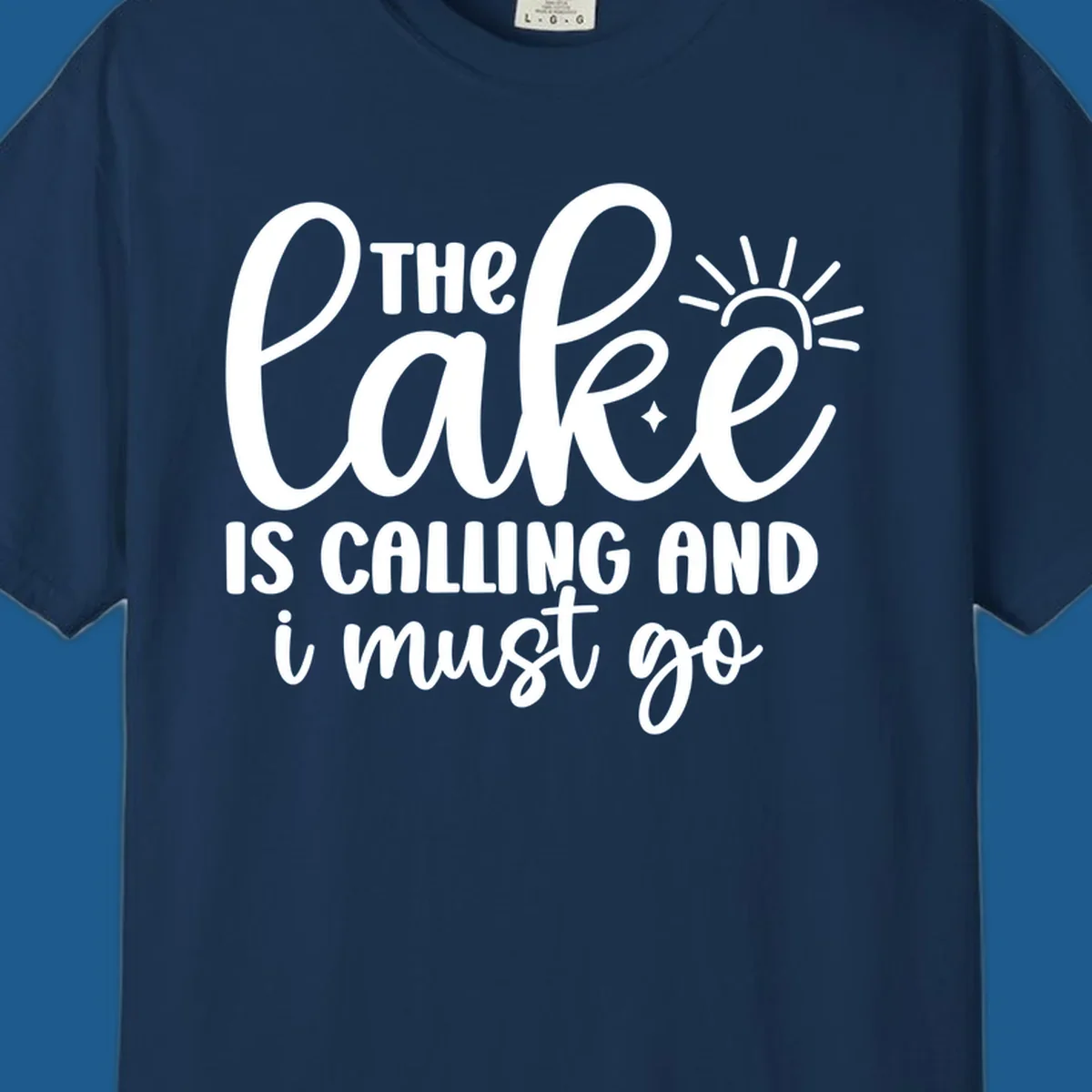The lake is calling and I must go text with sun and star graphic