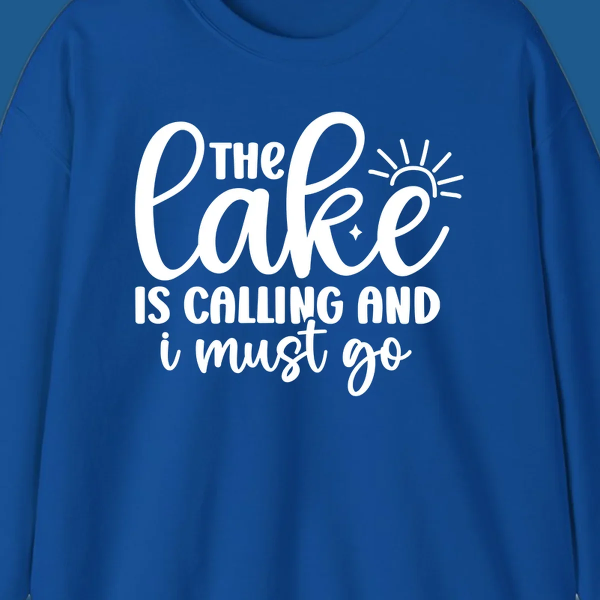The lake is calling and I must go text with sun and star graphic