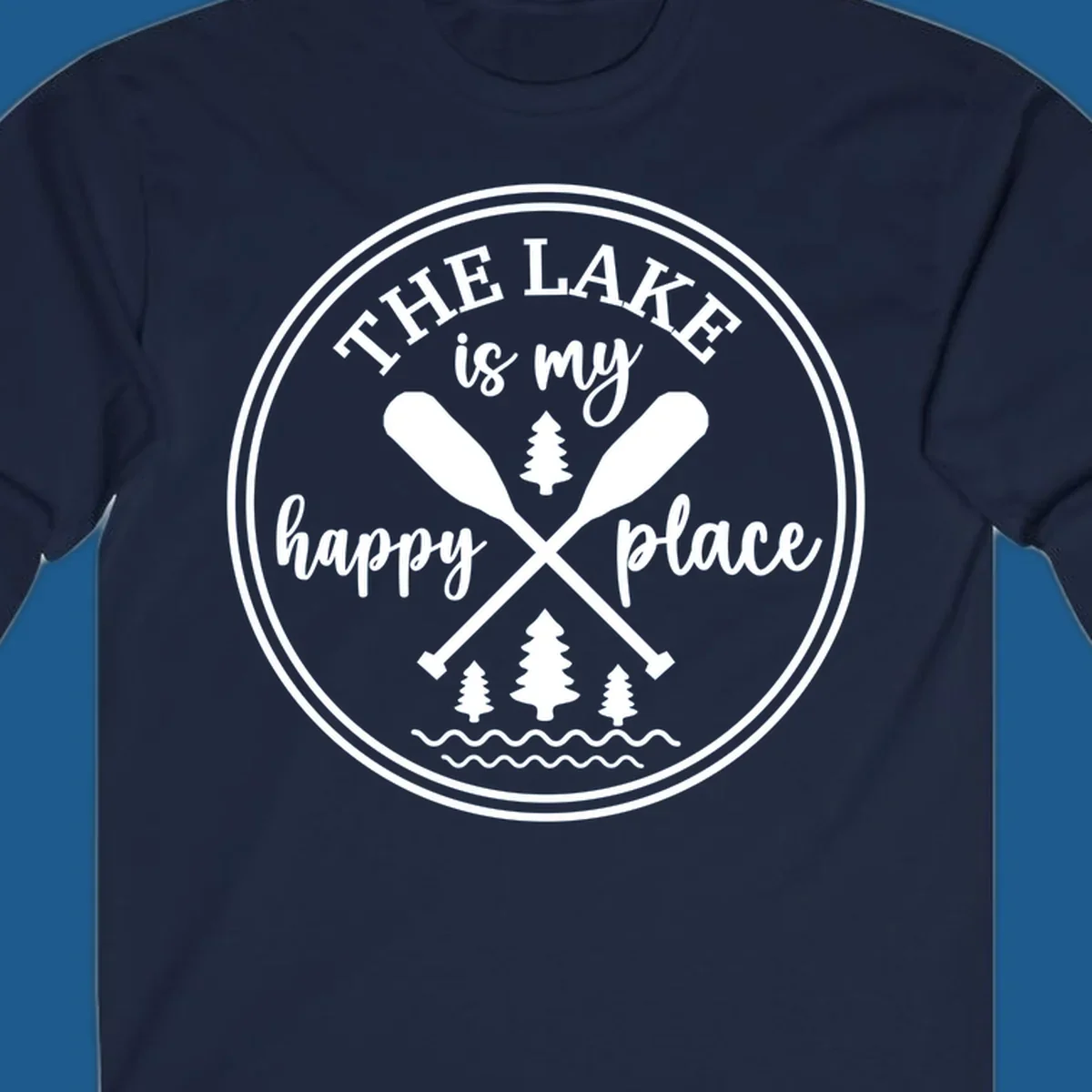Circular graphic with text 'The Lake is my happy place', crossed oars, and pine trees - lake-happy-place.